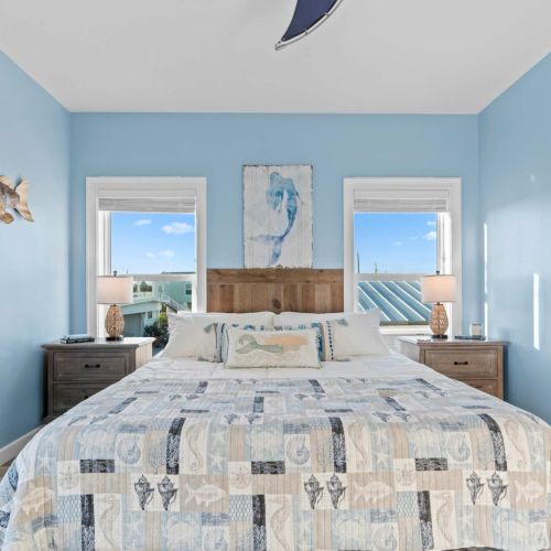 Escape to tranquility in this beautifully designed bedroom featuring coastal vibes and serene blue tones.