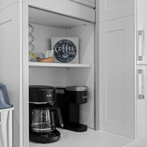 This stylish kitchen with white cabinets is your perfect coffee haven, ready for you to brew up some tasty memories. Whether it's a quiet morning or a lively brunch, this space invites you to gather and enjoy. Cheers to great moments and even better!