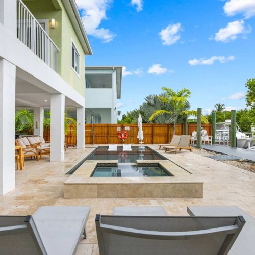Pool & spa: a heated pool and raised spa framed by palms and a private fenced yard.