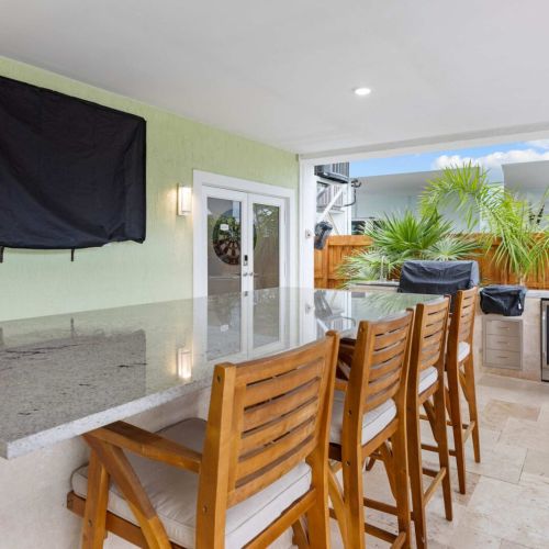 Outdoor bar: pull up a stool at the granite bar for game day under the covered patio.