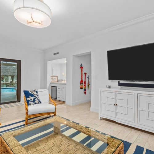 Kick back in the living room with pool views and a big screen for movie nights.