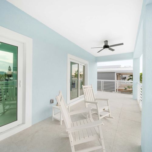 Bright white chairs invite you to unwind while enjoying calming waterfront views!