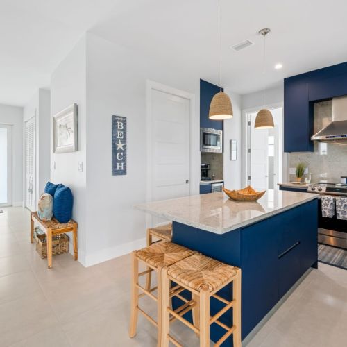 The kitchen island offers a fantastic dining setting for a homemade meal.