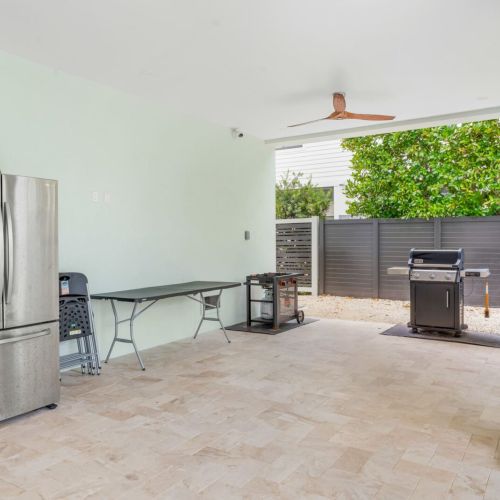 A fully stocked grilling area meets storage and prep space so every cookout runs smoothly. Keep drinks cold in the stainless fridge, toss something on the grill, and enjoy effortless outdoor living made for long, sunny keys afternoons.