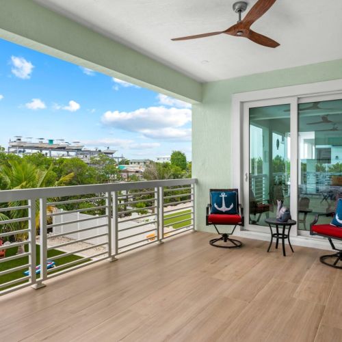 Sunshine floods the entire space by bursting through large windows and deck doors.