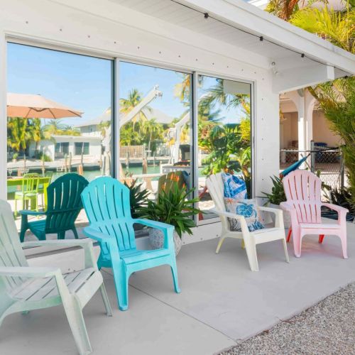 Escape to your perfect getaway with our charming patio! Picture yourself sipping coffee under the shade of colorful umbrellas, surrounded by lush plants and cozy chairs.