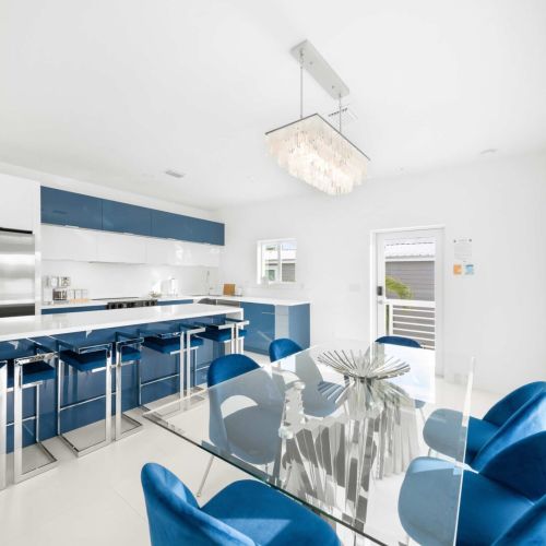 Experience culinary bliss in this bright, stylish kitchen with chic blue accents!