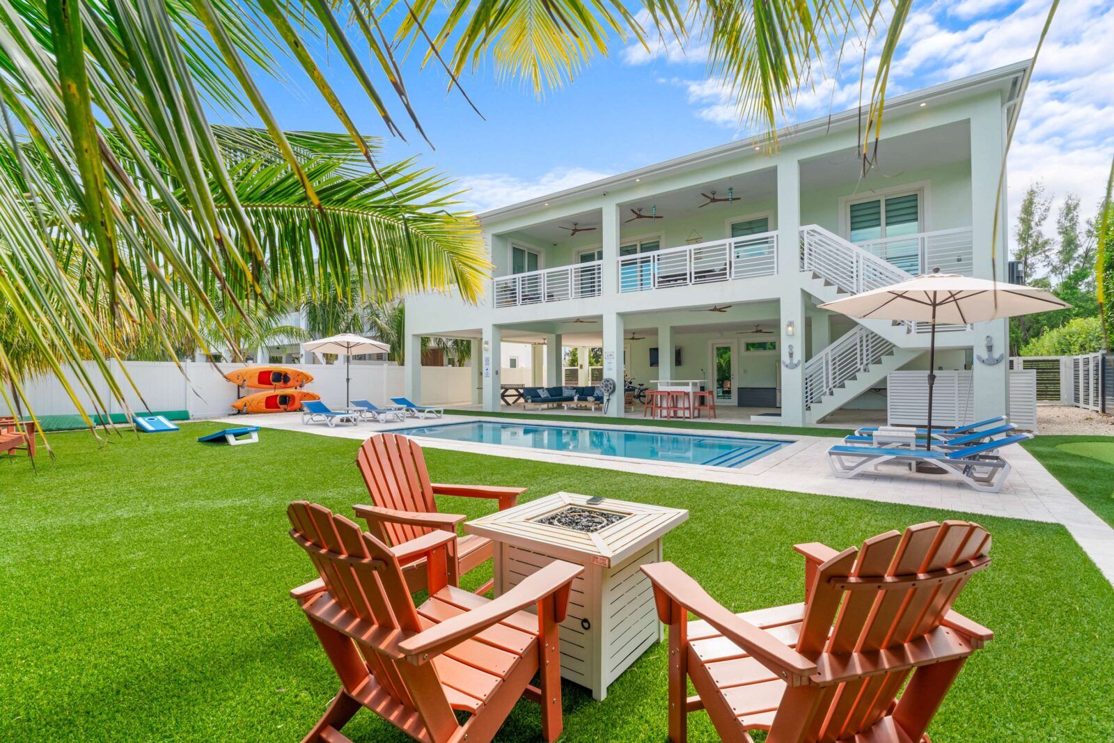 Backyard serenity meets tropical style. Lounge under the palms, grill by the pool, or unwind by the firepit as the sun sets over your private Emerald Oasis. Every detail invites relaxation and effortless island living.