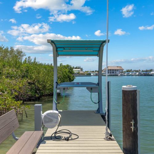A covered lift with freshwater hookup keeps your vessel secure between water days.
