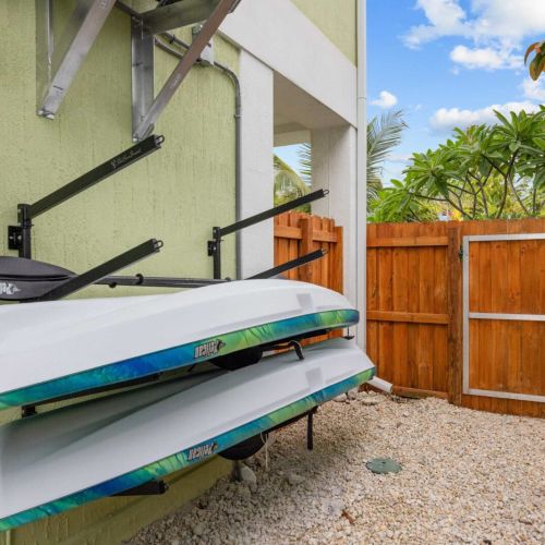 Kayak storage: two kayaks and paddles racked and ready for a morning on the water.