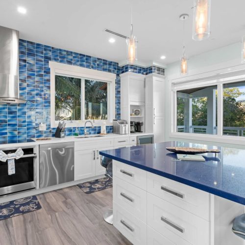 Step into this charming kitchen with its striking blue tile that adds a splash of personality! Whether you’re whipping up a gourmet meal or enjoying a comfy breakfast, this space is perfect for both chefs and casual cooks alike.