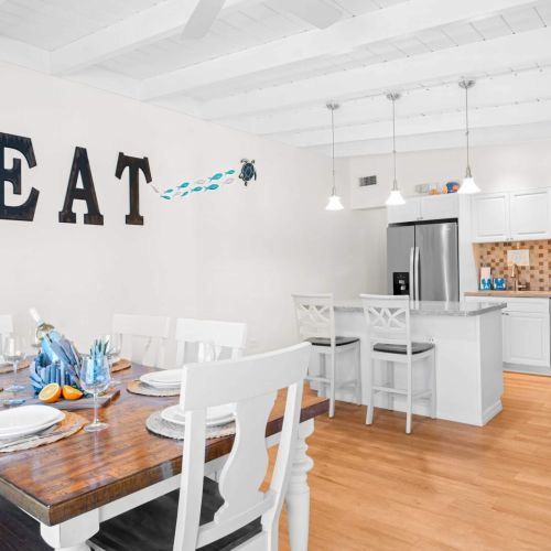 With sleek white cabinets and modern appliances, this space invites you to whip up delicious meals or enjoy a cozy breakfast. Gather around the dining table and make lasting memories—it’s where every great meal begins!