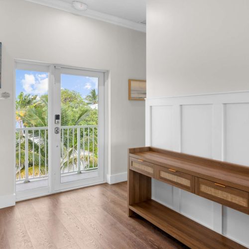 Foyer: a welcoming entry with a console table and balcony doors to the breeze.