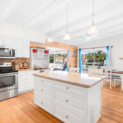 Step into this charming kitchen with its sleek white cabinets, perfect for whipping up your favorite meals or enjoying a cozy breakfast. It's the heart of the home where you can unleash your inner chef!