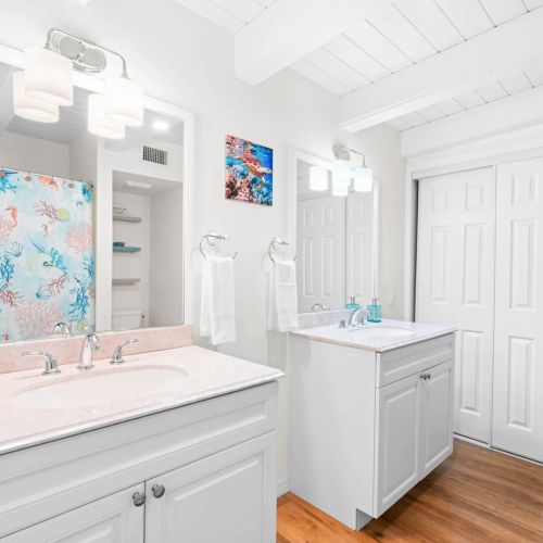 Our fresh and stylish bathroom features crisp white cabinets that shine bright. Whether you're unwinding in the bathtub or enjoying a refreshing shower, this space is all about comfort and charm.