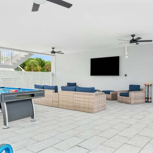 Covered lounge area with pool table and big tv. Chill in the shade while staying close to the action.