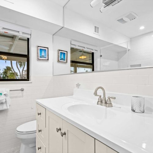 Bright and fresh bathroom with plenty of counter space and natural light.