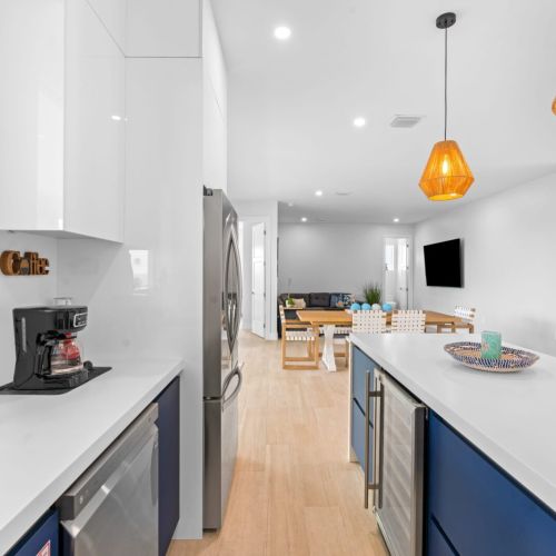 Take a peek at this cozy kitchen featuring a sleek refrigerator and a gleaming sink