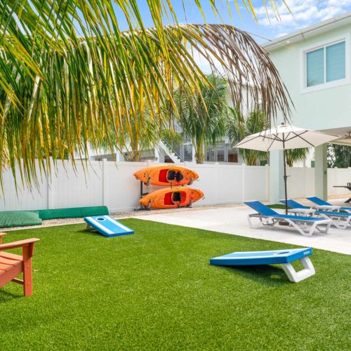 Backyard built for pure florida keys fun. Toss a few cornhole bags, grab the kayaks for a canal cruise, or unwind poolside under the palms. Every inch of this space was made for sun, laughter, and laid-back island living.