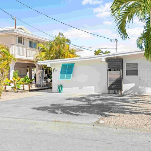 Escape to your very own tropical paradise! Nestled among palm trees and under a brilliant blue sky.