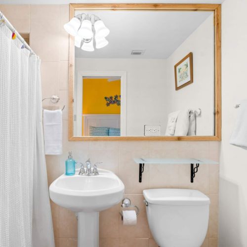 Step into serenity in our cozy bathroom oasis. With a spacious mirror and sleek sink, this is the perfect spot to refresh and unwind after a day of adventure.