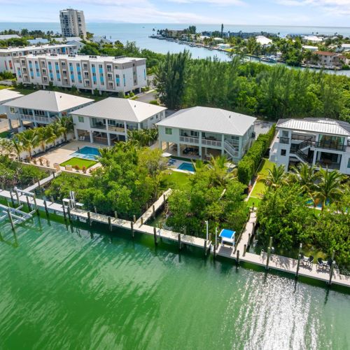 Emerald oasis from the water is pure florida keys tranquility. Perfectly positioned along a wide canal, it offers easy ocean access, lush privacy, and resort-style living—all framed by emerald palms and endless blue horizons.