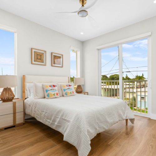 Wake up to florida keys sunshine in this serene bedroom retreat with hardwood floors and coastal breezes.