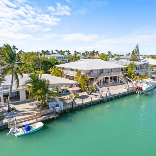 Imagine waking up to stunning views of the water, surrounded by charming buildings and vibrant palm trees.