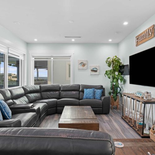 This cozy living room, complete with a sleek black couch, invites you to unwind and relax. Sip your morning coffee or kick back after a day of adventures—this space is designed for both comfort and style. Perfect for making memories during your stay!