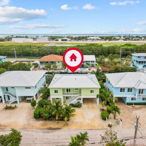 Aerial: set among classic keys homes with the bay shimmering just past the rooftops.