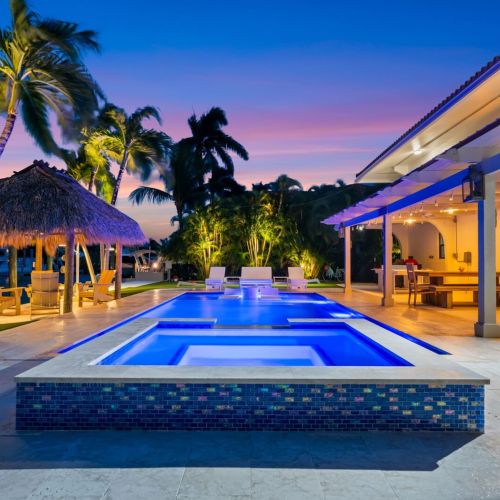 Evenings hit different here. Heated pool, glowing lights and tropical sunsets right from the backyard.