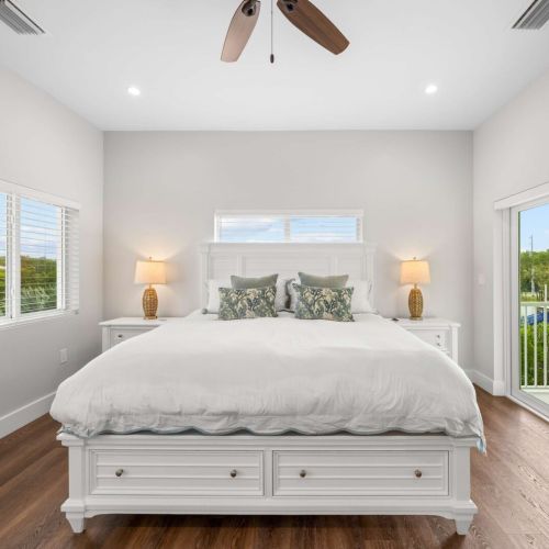 King suite: drift off with private balcony doors framing the keys sky.