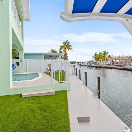 Your private putting green meets waterfront paradise with heated pool, spacious dock, and endless opportunities for outdoor fun and relaxation.
