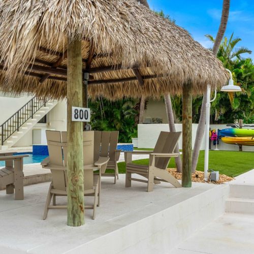 Tiki lounge by the water. Kayaks ready, drinks welcome, pure keys energy.