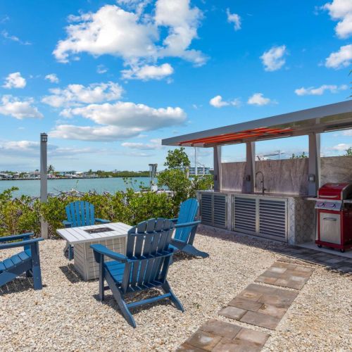 Grill your catch at the stone-backed kitchen while your group gathers around the fire table.