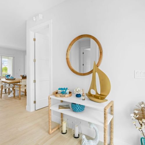 Step into this cozy living room, complete with a stylish table and a chic mirror. ✨