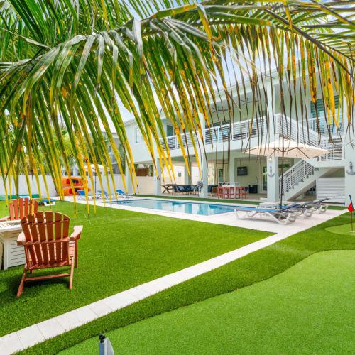 Tropical seclusion meets fun and relaxation. Swing under the palms, sink a few putts on the green, then cool off in the pool or gather by the firepit. Every detail is designed to make outdoor living feel effortless and alive.