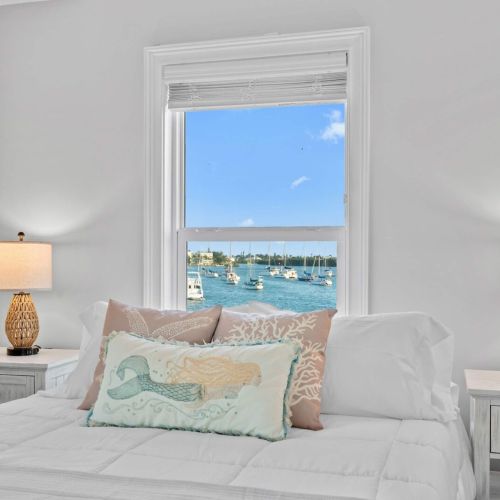 Drift off to sleep with stunning harbor views and elegant coastal decor!