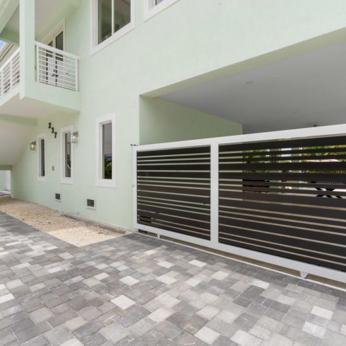 Behold this stunning large white house surrounded by lush greenery, a perfect blend of elegance and nature's beauty.