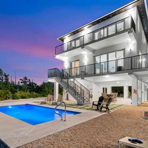 Glow into the night. Heated pool, cornhole, and cocktails under the balcony lights.