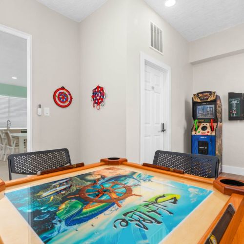 Arcade + darts + domino table = game night locked in. This room keeps the competition going while everyone else chills by the pool.