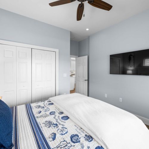 Bedroom 1: cozy blues and crisp linens with the kitchen just down the hall.