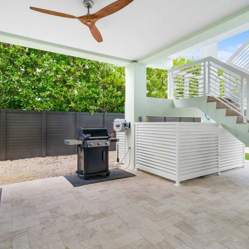 Outdoor cooking made easy with everything you need right under the shade. Fire up the grill, prep on spacious counters, and enjoy a seamless flow between the backyard, pool, and upstairs dining area. Designed for easygoing keys cookouts.